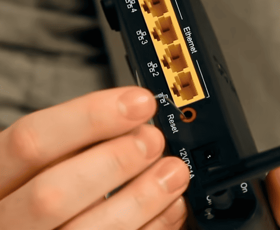 Hold the Reset Button on Arris Modem and Router with paperclip
